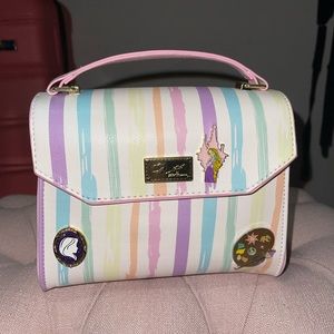 Betsey Johnson bag with Disney Tangled pins.